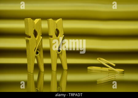 Two photo clips and a paperclip on yellow background. Stock Photo