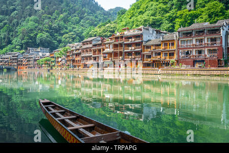Scenic view of Fenghuang phoenix ancient town with Tuo Jiang river boat and old houses in Hunan China Stock Photo