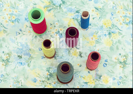spools on floral background Stock Photo