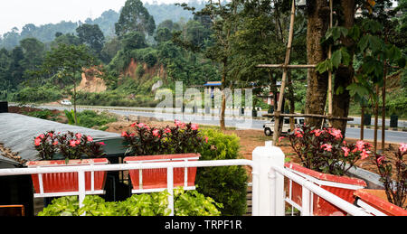 Front yard of a holiday house from veranda. Beautiful romantic patio decorated with flowers in spring. Pelling Sikkim India himalayan mountain city vi Stock Photo