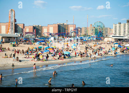 NEW YORK CITY - AUGUST 20, 2017: Crowds of people flock to the Coney Island beach and boardwalk on a hot summer weekend. Stock Photo