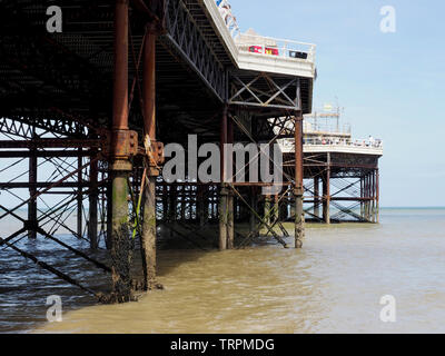 The view underneath the famous Cromer Pier in Norfolk showing the complex steel and concrete structure. Stock Photo