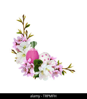 Corner arrangement with spring branches of peach and apple flowers  and Easter painted eggs isolated on white background Stock Photo