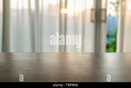 Wood table top on blurred soft curtain at sunset Stock Photo