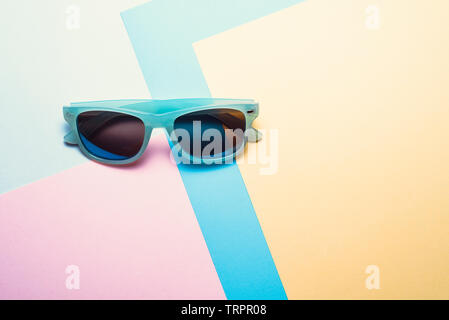 sunglasses on pastel multicolor paper trendy background with geometric shapes. Creative fashion minimal concept. Stock Photo