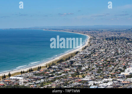 View of Tauranga from Mount Maunganui in New Zealand. The surf rolls on to the perfect sandy beach Stock Photo