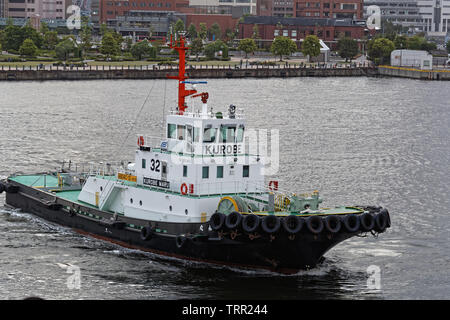 YOKOHAMA, JAPAN, May 20, 2019 : Tugboat in the harbour of Yokohama. Yokohama Port has ten major piers and serves 38000 ships a year. Stock Photo