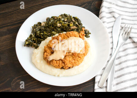Chicken Fried Steak and Gravy with Mashed Potatoes and Collard Greens Stock Photo