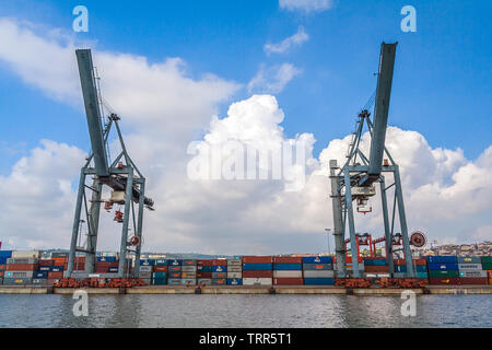Lisbon, Portugal - November 05, 2018: Porto de Lisboa or International Port of Lisbon in the Tagus River. Cranes and shipping containers Stock Photo