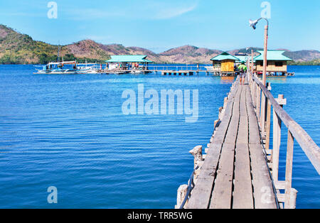 A small pier in Coron serves the need for boats to dock and load and unload passengers/tourists for  inter island travel. Stock Photo