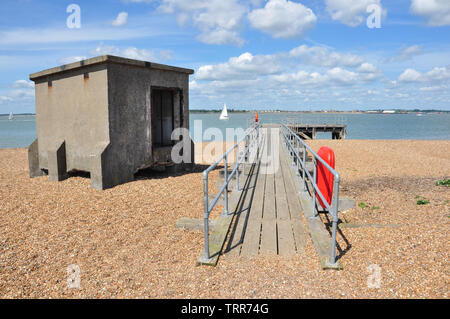 Old concrete shelter and timber jetty near Landguard Fort, Felixstowe, Suffolk, England, UK Stock Photo