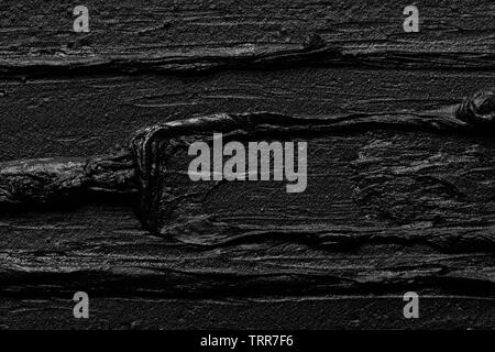 Texture of black crushed eyeliner or black acrylic paint isolated on white background Stock Photo