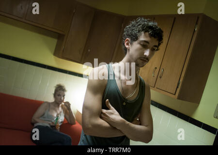 portrait of young caucasian adult in his mother’s kitchen at twilight Stock Photo