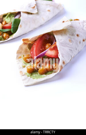 Vegan wraps in pita with chickpeas and mashed avocado isolated on white background Stock Photo