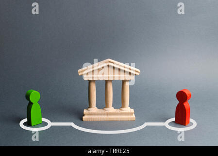 Two figures of people contact in bypassing the state building or bank. Direct negotiations and an agreement to bypass the government or the bank. Ille Stock Photo