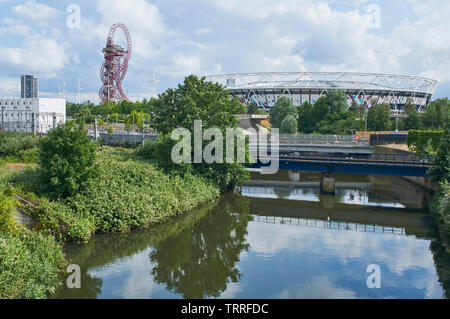 The River Lea at London Olympic Park, with the London Stadium and the ArcelorMittal Orbit in background Stock Photo