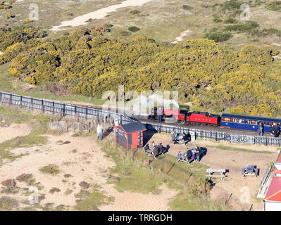 A Romney, Hythe and Dymchurch Railway, RH&DR, steam locomotive and train at Dungeness station from the top of the old lighthouse. Dungeness, Kent, UK Stock Photo