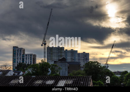 London, England, UK - June 1, 2019: The sun sets behind the remaining tower blocks of the Alma Estate during regeneration of the housing in the Ponder