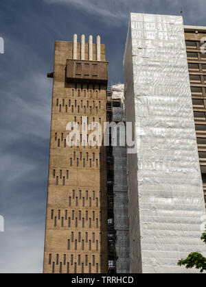 London, England, UK - June 1, 2019: Scaffolding partially wraps the brutalist concrete Balfron Tower during refurbishment works in Poplar, East London Stock Photo