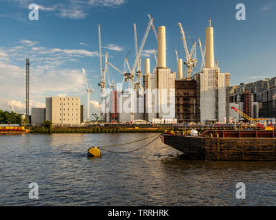 London, England, UK - May 28, 2019: Tower cranes surround the Battersea Power Station during regeneration of the post-industrial Nine Elms neighbourho Stock Photo