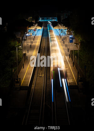 Winchester, England, UK - April 22, 2019: A South Western Railway passenger train calls at Winchester Railway Station in Hampshire at night. Stock Photo