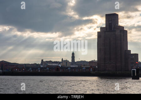 The Birkenhead skyline, including Birkenhead Town Hall clock tower and the Queensferry Tunnel ventilation building, stand on the banks of the River Me Stock Photo