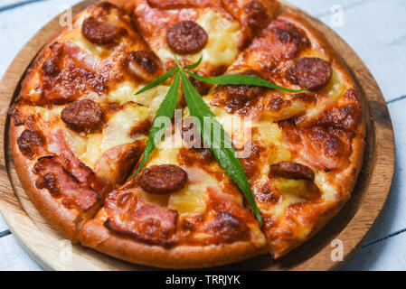 cannabis food withPizza on wooden tray and chilli basil leaf top view / delicious tasty fast food italian traditional pizza cheese with Mozzarella , S Stock Photo