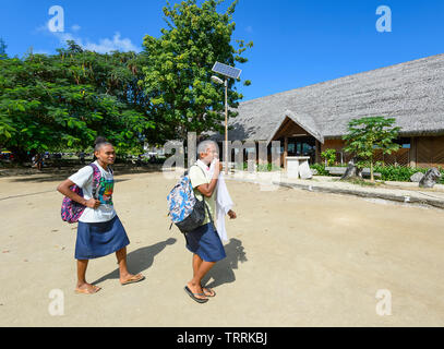 Two young Melanesian girls walking past the Art and Craft Market, Port Vila, Vanuatu, Melanesia Stock Photo