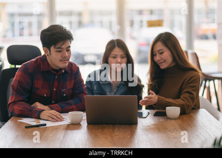 Three asian businessman working and presenting business in a meeting Stock Photo