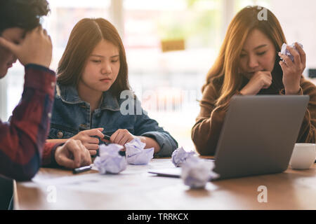 Three businessman get stressed while having a problem in business meeting Stock Photo