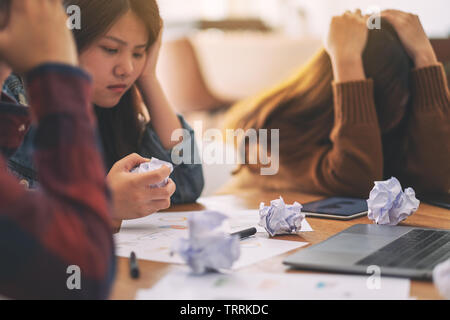 Three businessman get stressed while having a problem in business meeting Stock Photo