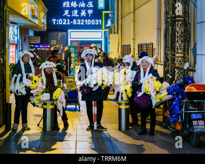 SHANGHAI, CHINA - 12 MAR 2019 – Middle aged women street vendors peddle Pokemon merchandise along East Nanjing Road (Nanjing Dong Lu) pedestrian stree Stock Photo