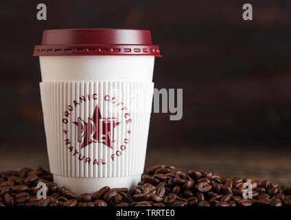 LONDON, UK - JUNE 05, 2019: Pret A Manger Coffee Paper Cup for take away with coffee beans on wood. Stock Photo