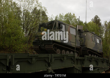 Norwegian soldiers drive a Norwegian Bandvagn 206 over a Medium Girder Bridge during exercise Thunder Reindeer 19 in Setermoen, Norway, June 6, 2019. Thunder Reindeer 19 is a multilateral, combined-arms, live-fire exercise that improves interoperability between the Norwegian Armed Forces and U.S. Marine Corps. (U.S. Marine Corps photo by Sgt. Williams Quinteros) Stock Photo