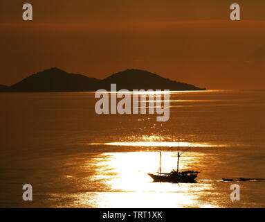 Sunset over the Flores sea near Labuan Bajo in Flores, Indonesia. Stock Photo