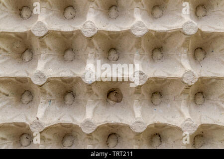 Top view surface sheet of empty cardboard egg crate or eggs carton box made of foam type brown color packing sheet. Old vintage look. Close up. Natura Stock Photo