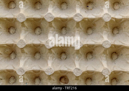 Top view surface sheet of empty cardboard egg crate or eggs carton box made of foam type brown color packing sheet. Old vintage look. Close up. Natura Stock Photo