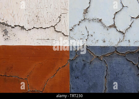 Four Rectangles Of Different Coloured Peeling Paints On An Old Cracked Shop Front In London's East End Stock Photo