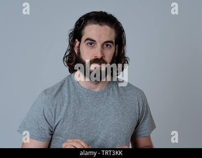 Portrait of funny attractive hipster man with happy and surprised face looking excited at something shocking good and unexpected. Human emotions and e Stock Photo