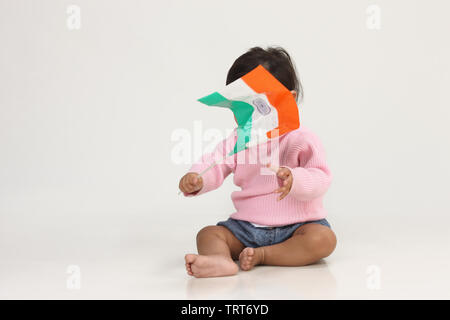 Indian baby girl holding an Indian flag Stock Photo