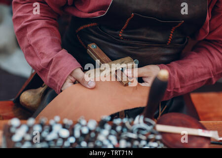 Tanner puts a pattern on leather Stock Photo