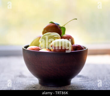 Fresh jujube on wooden table. Unabi fruit. Stock Photo