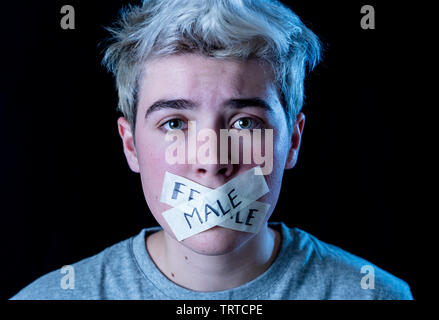 Transgender teenager with mouth sealed on tape with words male and