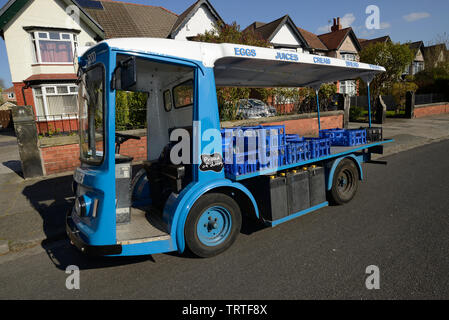 England UK Electric milk float on the cobbled street of a historic city ...