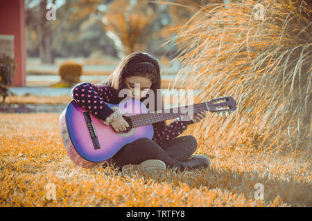 Little girl playing the guitar Stock Photo