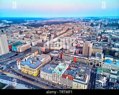WARSAW, POLAND - APRIL 07, 2019: Beautiful panoramic aerial drone view to the center of Warsaw City in the sunset time in spring Stock Photo