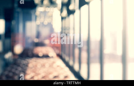 Blurred abstract light gold glass wall from building room background. Stock Photo