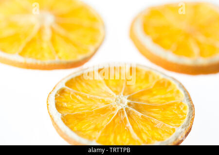 Three dried orange slices isolated on white background - selective focus Stock Photo