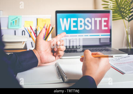 Website or web design concepts with young man working with computer laptop and accessories on worktable.creativity and development images Stock Photo