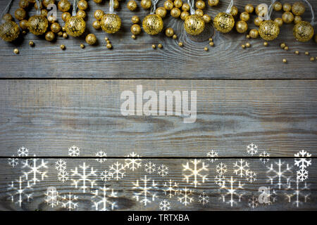 Christmas rustic background with snow flakes and golden balls on wooden boards Stock Photo